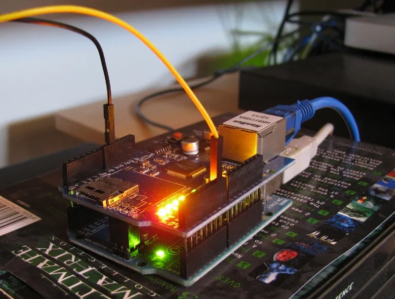 The stacked Arduino and Ethernet shield, on an insulating box.