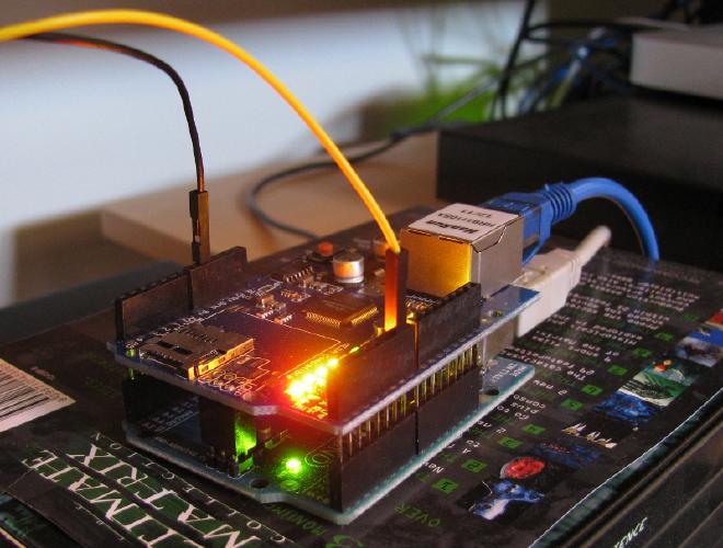 The stacked Arduino and Ethernet shield, on an insulating box.